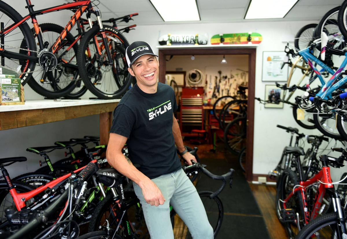 Archival photograph of Ryan DeWald with bicycles inside Skyline, 2016
